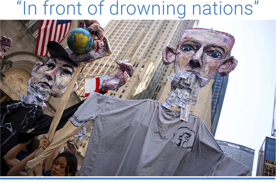 Art pieces of Mark Zuckerberg and Elon Musk with bloody hands carrying globes are marched through Manhattan at the “Make Billionaires Pay” climate protest, September 2025, in New York. Photo: Angelina Katsanis/AP.
