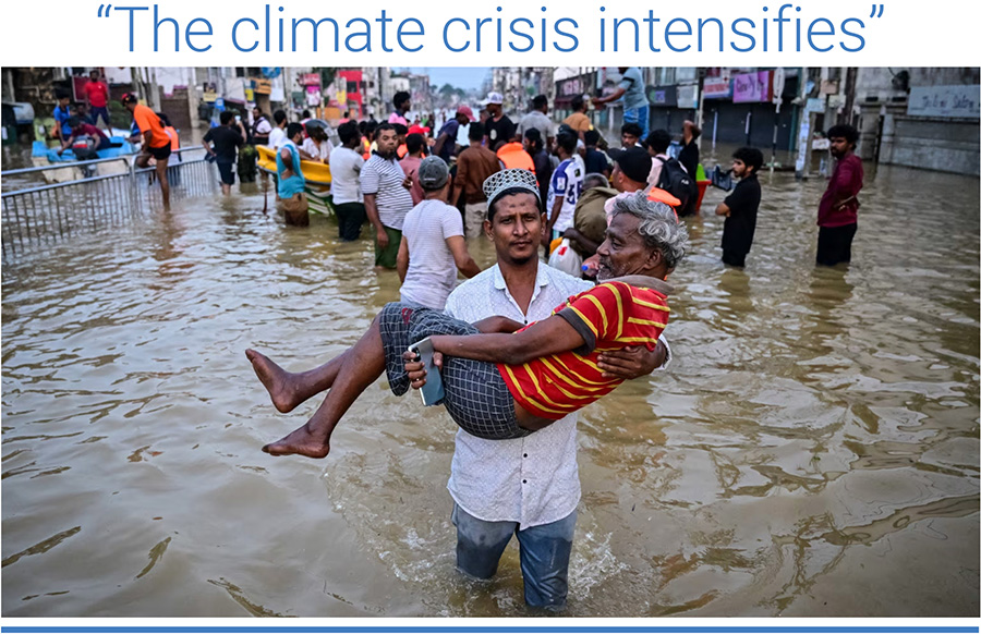 A youth carries an elderly man as they wade through a flooded street after heavy rainfall in Wellampitiya on the outskirts of Colombo. Photo: Ishara S. Kodikara/AFP/Getty Images.