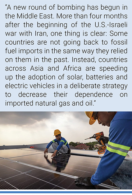 Workers install solar panels on the roof of a house in Antipolo, Philippines. In the wake of the Iran war, the Philippines imported more than $400 million in solar panels from February to May. Photo credit: Ezra Acayan/Getty Images.