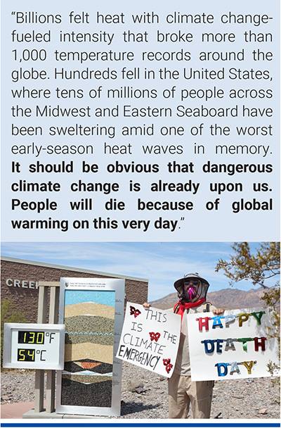 A protester stands next to a digital display of an unofficial heat reading during a heat wave in Death Valley National Park in Death Valley, California. Photo: Ronda Churchill/AFP/Getty Images.